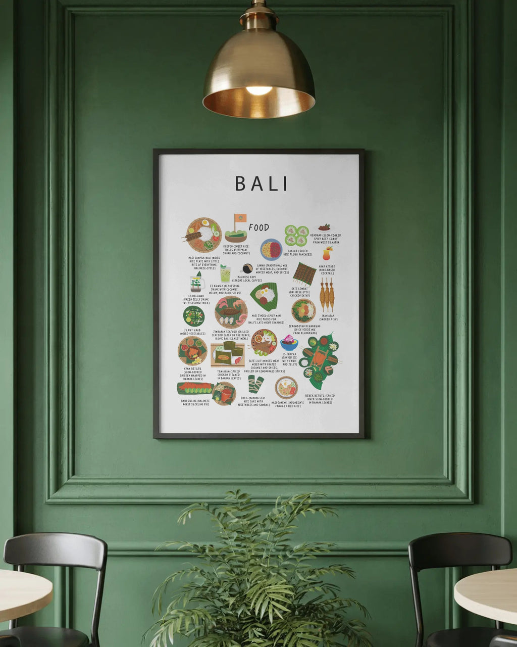 A framed Bali food poster hangs on a paneled green wall under a brass pendant light, above a potted plant and dining chairs.