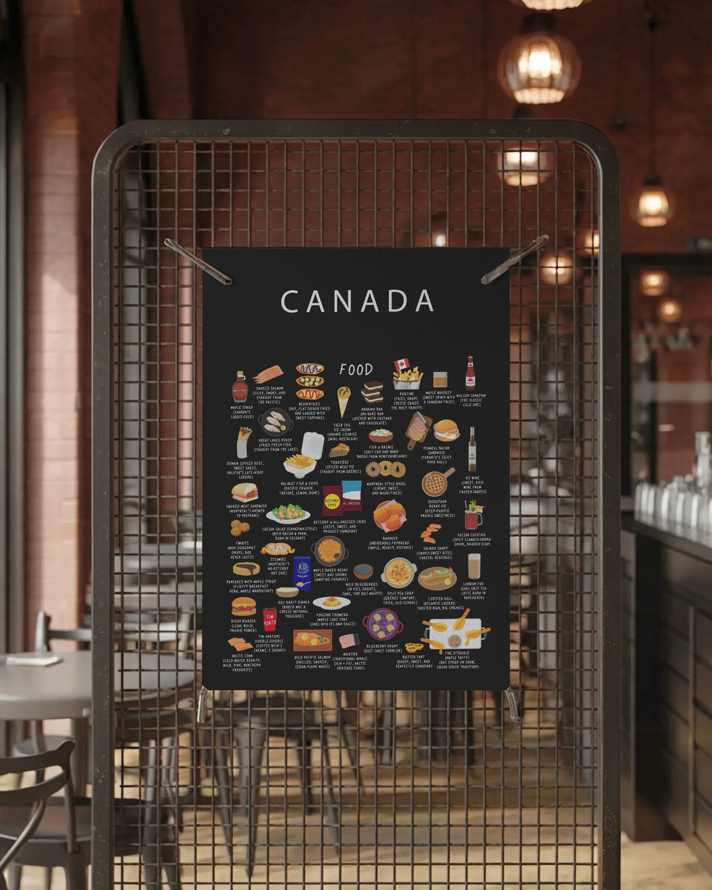 A black Canada food poster clipped to a metal wire mesh screen in a restaurant with tables and warm ambient lighting in the background.
