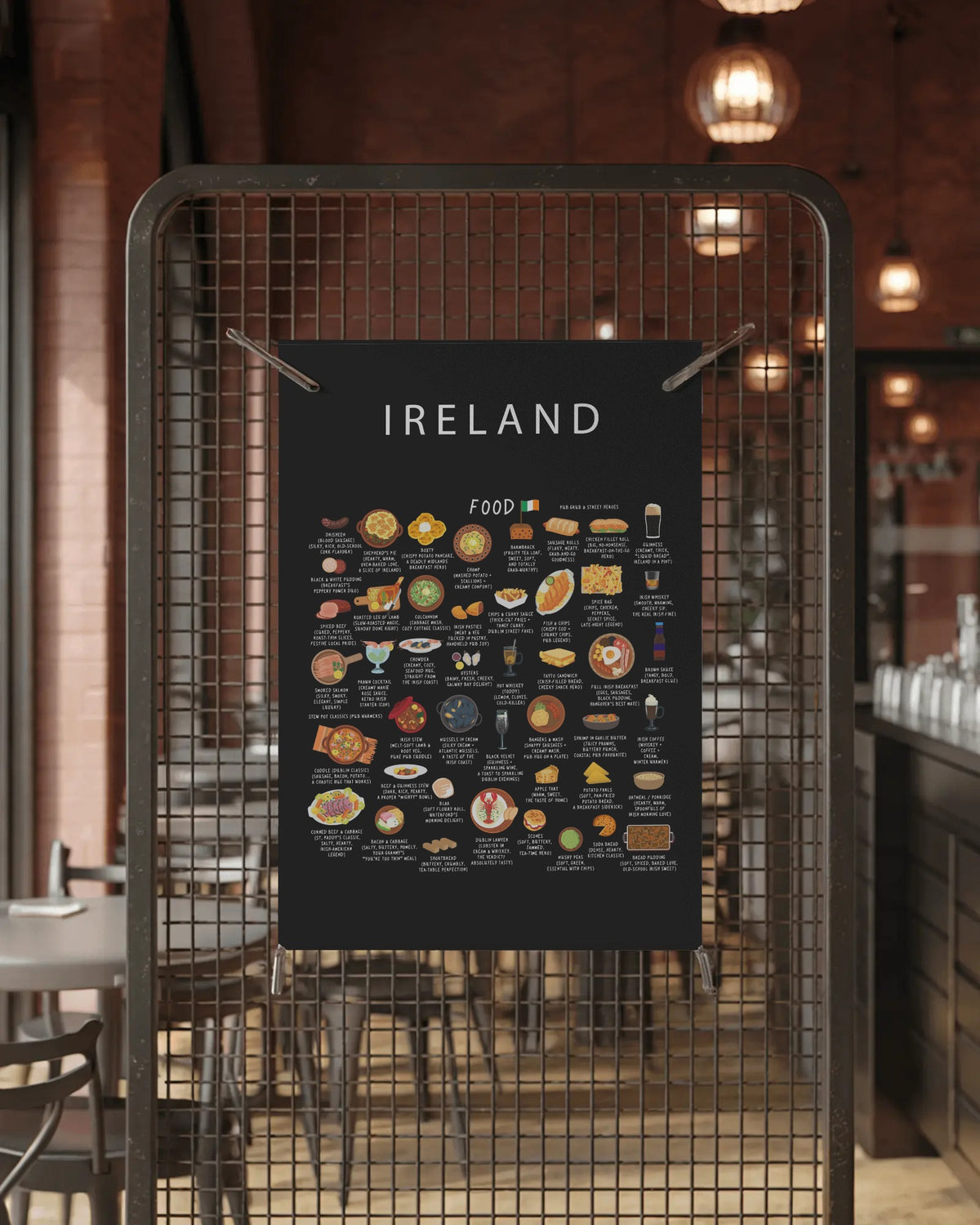 A black Ireland food poster clipped to a metal wire mesh screen inside a warm, dimly lit restaurant interior.